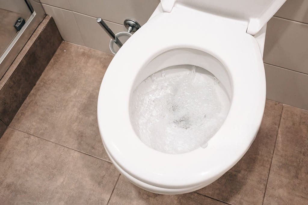 Toilet Bubbling caused by a possible sewer line blockage or plumbing vent issue.